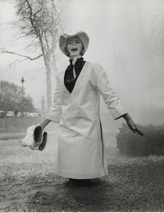Model Jill Kennington wearing a white PVC rain tunic and hat, photographed by John Cowan, 1963. .jpg